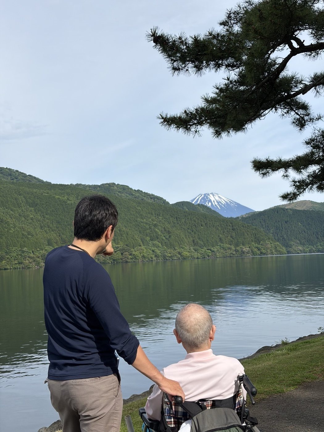 芦ノ湖のほとりから富士山をながめるご利用者様とスタッフ